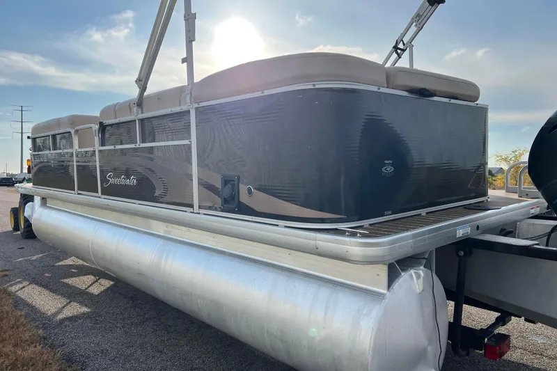 Slide: The Image of 2013 Godfrey Sweetwater 2286 pontoon boat parked on a sunny day. - 5