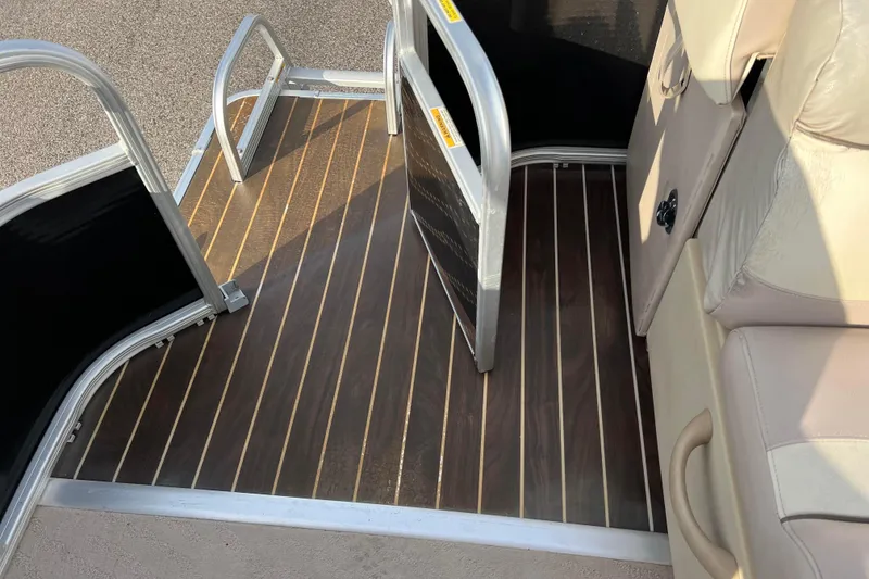 Slide: The Image of 2013 Godfrey Sweetwater 2286 boat interior with wood-patterned flooring and seating. - 55