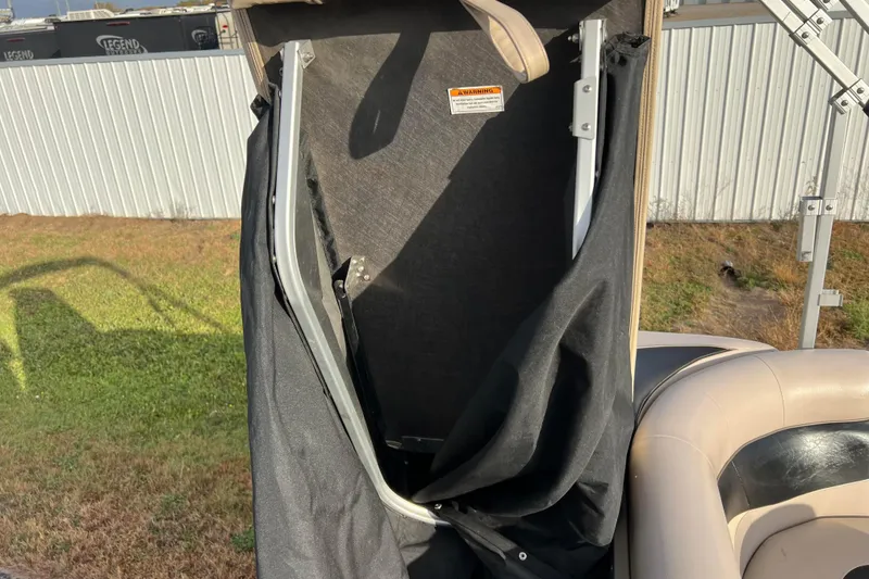 Slide: The Image of 2013 Godfrey Sweetwater 2286 boat interior with partially folded canopy. - 57