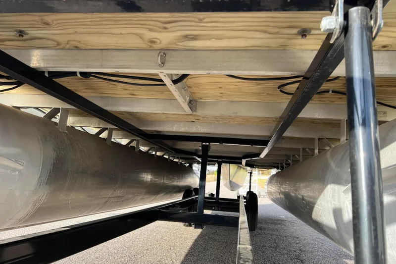Slide: The Image of Underneath view of a 2013 Godfrey Sweetwater 2286 pontoon boat, showcasing pontoons and frame. - 8
