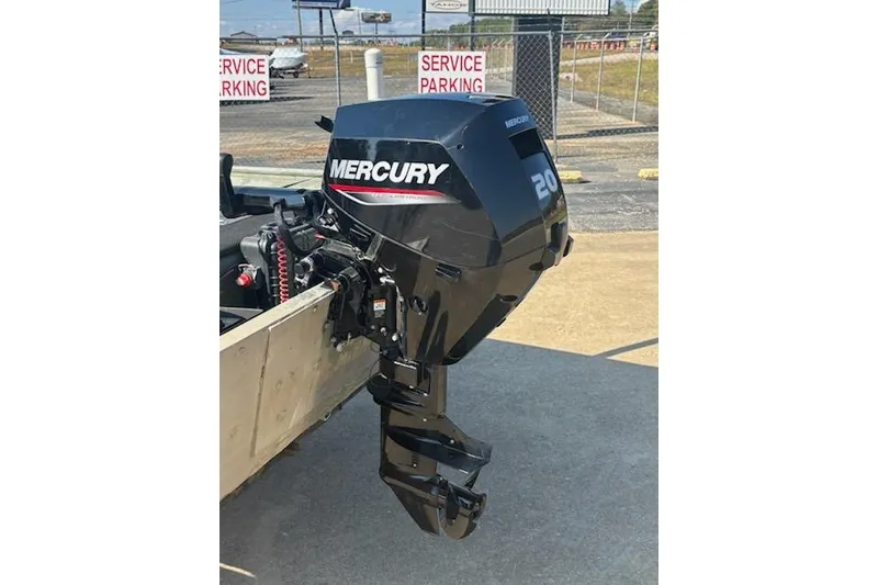 Slide: The Image of 1981 Lowe L1448 Jon boat with Mercury 20 HP outboard motor in service parking area. - 4