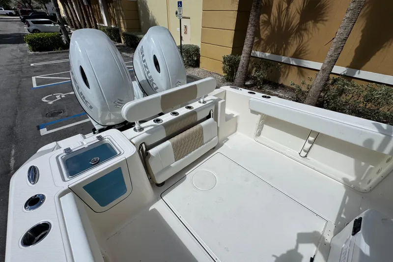 Slide: The Image of 2026 Bulls Bay 255CC boat with dual Suzuki engines, parked in a sunny lot. - 11