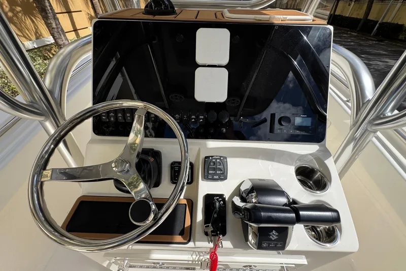 Slide: The Image of 2026 Bulls Bay 255CC boat console with steering wheel and controls. - 15