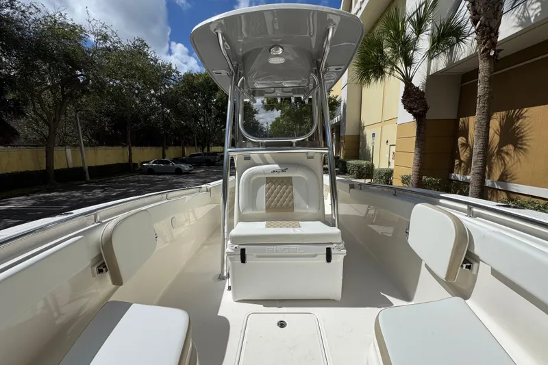 Slide: The Image of 2026 Bulls Bay 255CC boat interior with seating and T-top under sunny skies. - 19