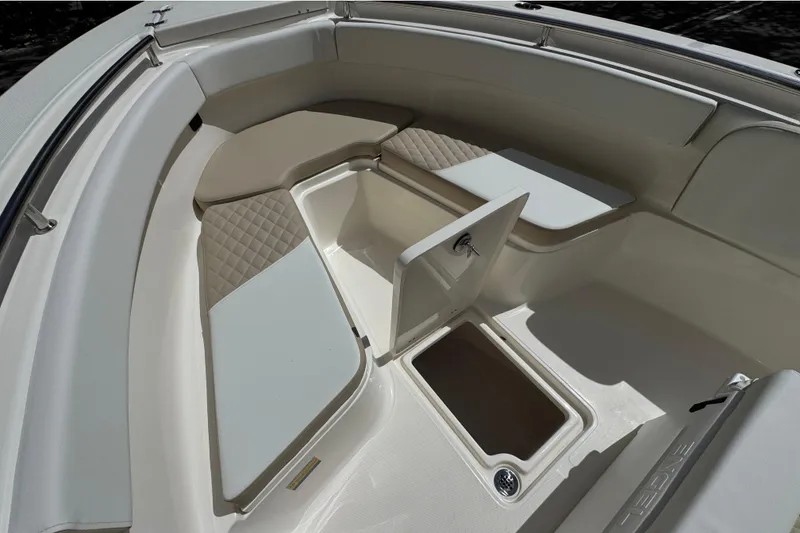 Slide: The Image of 2026 Bulls Bay 255CC boat interior with cushioned seating and storage compartment. - 21
