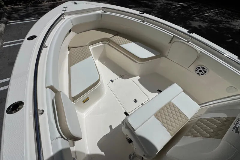 Slide: The Image of 2026 Bulls Bay 255CC boat interior with cushioned seating and storage compartments. - 23