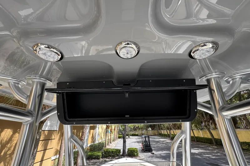 Slide: The Image of 2026 Bulls Bay 255CC boat interior with overhead lights and storage compartment. - 24