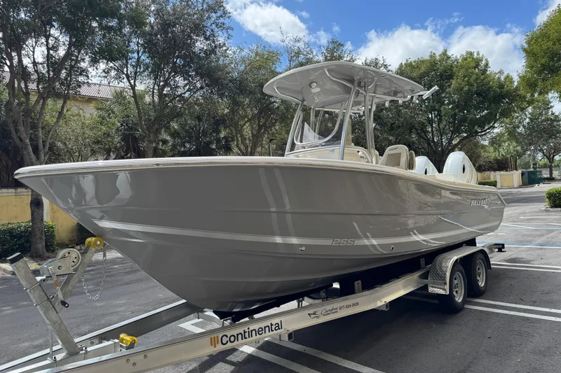 Slide: The Image of 2026 Bulls Bay 255CC boat on trailer, parked outdoors under a clear sky. - 3