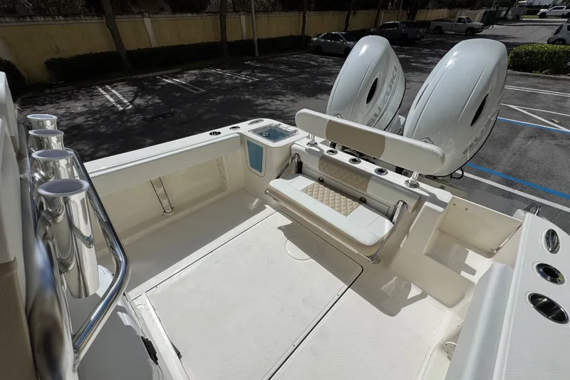 Slide: The Image of 2026 Bulls Bay 255CC boat with dual engines and seating in a parking lot. - 7