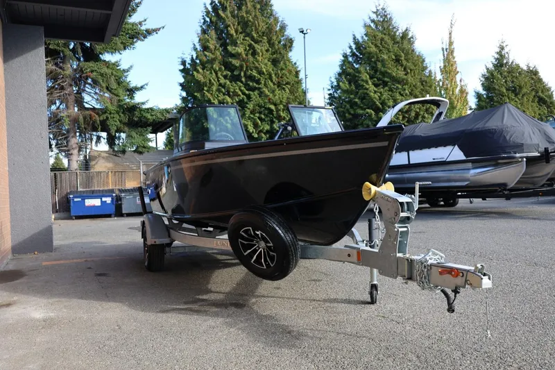Slide: The Image of 2026 Lund 1800 Explorer Sport boat on trailer, parked outdoors. - 10