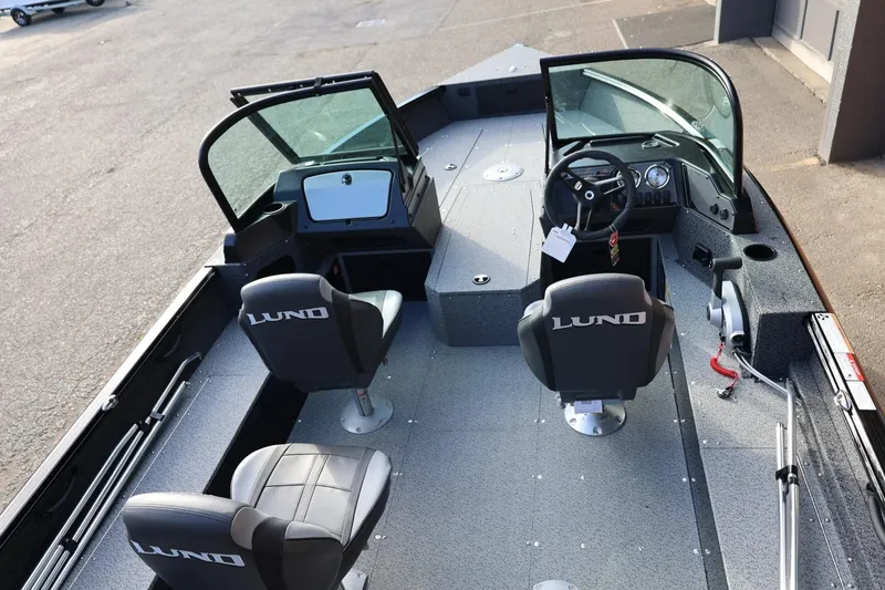 Slide: The Image of 2026 Lund 1800 Explorer Sport boat interior with dual seats and steering console. - 15