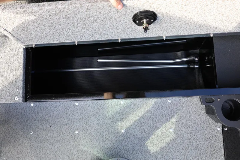 Slide: The Image of 2026 Lund 1800 Explorer Sport boat storage compartment with open lid and interior view. - 19