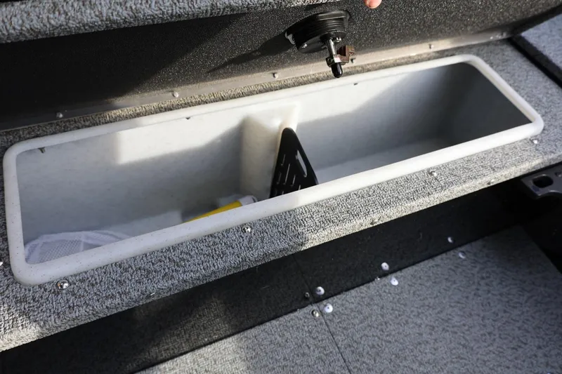 Slide: The Image of 2026 Lund 1800 Explorer Sport boat storage compartment with open lid. - 20