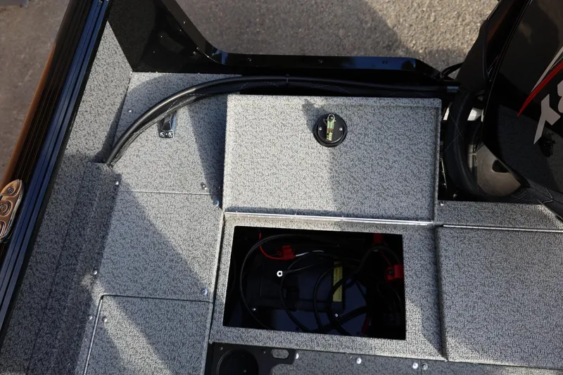 Slide: The Image of 2026 Lund 1800 Explorer Sport boat interior with open battery compartment. - 21