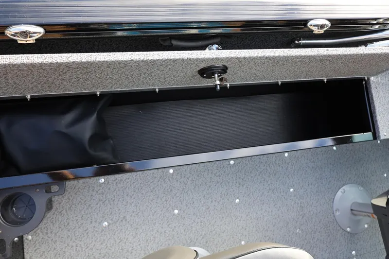 Slide: The Image of 2026 Lund 1800 Explorer Sport boat storage compartment, open and empty. - 22