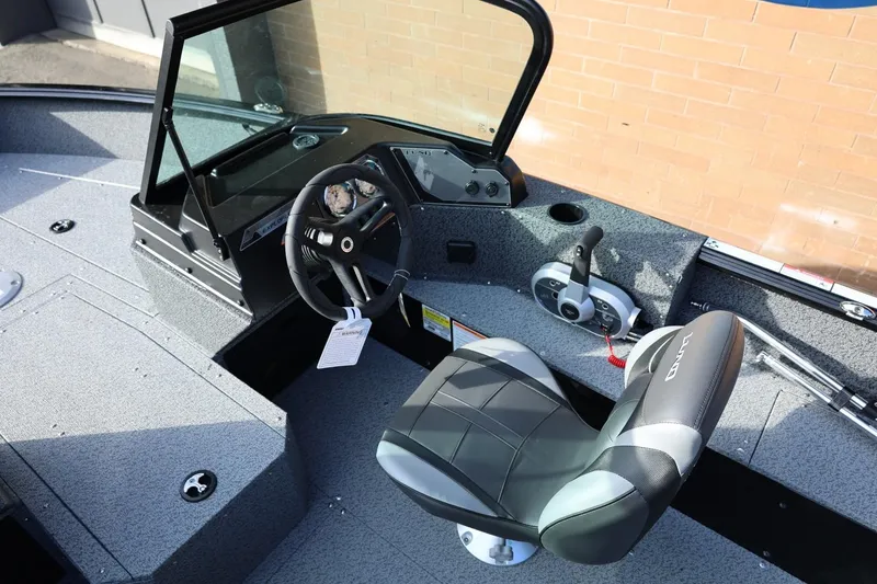 Slide: The Image of 2026 Lund 1800 Explorer Sport boat interior with steering wheel and seat. - 28