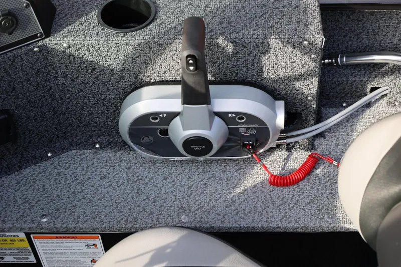 Slide: The Image of Control panel of 2026 Lund 1800 Explorer Sport boat with throttle and safety features. - 29