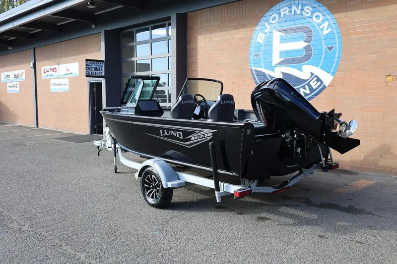 Slide: The Image of 2026 Lund 1800 Explorer Sport boat on trailer outside Bjornson Marine building. - 3