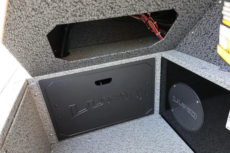 Slide: The Image of Interior of 2026 Lund 1800 Explorer Sport boat, featuring storage compartments and wiring. - 34