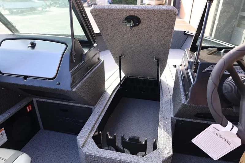 Slide: The Image of 2026 Lund 1800 Explorer Sport boat interior with open storage compartment. - 36