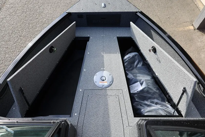 Slide: The Image of 2026 Lund 1800 Explorer Sport boat interior with open storage compartments. - 37