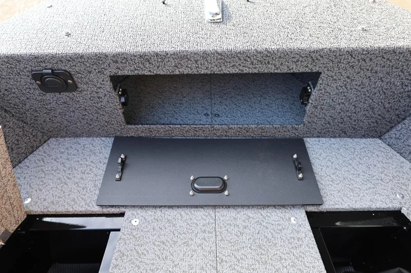 Slide: The Image of 2026 Lund 1800 Explorer Sport boat storage compartment with textured interior and secure latch. - 38