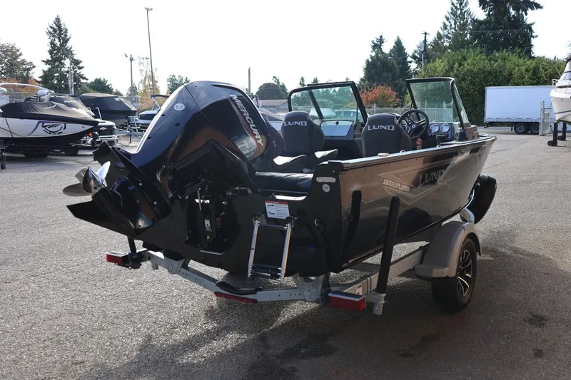 Slide: The Image of 2026 Lund 1800 Explorer Sport boat with Mercury engine on trailer in outdoor setting. - 7