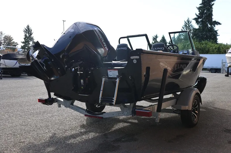 Slide: The Image of 2026 Lund 1800 Explorer Sport boat on trailer, featuring a powerful Mercury outboard motor. - 8