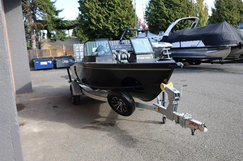 Slide: The Image of 2026 Lund 1800 Explorer Sport boat on trailer in outdoor setting. - 9
