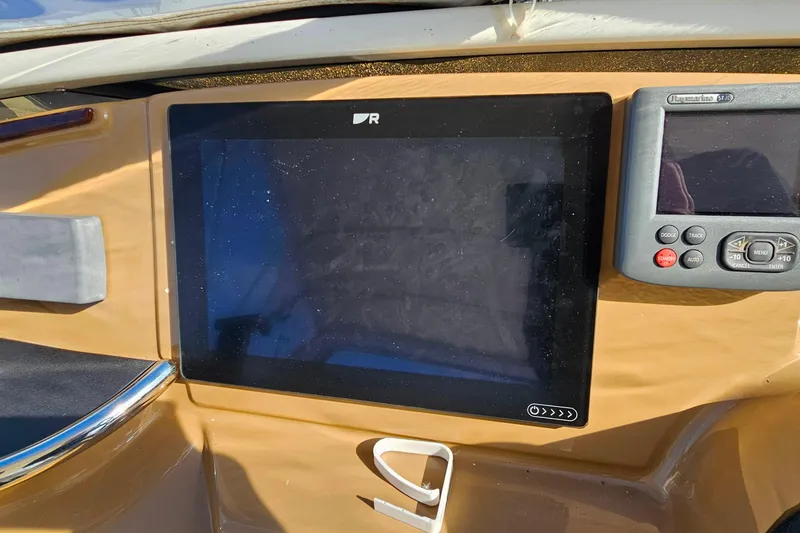 Slide: The Image of Dashboard of 2004 Carver 444 Cockpit Motor Yacht with navigation screens. - 17