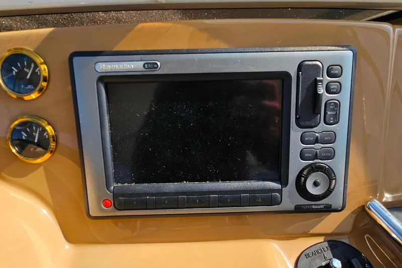 Slide: The Image of Control panel of a 2004 Carver 444 Cockpit Motor Yacht with navigation display. - 18