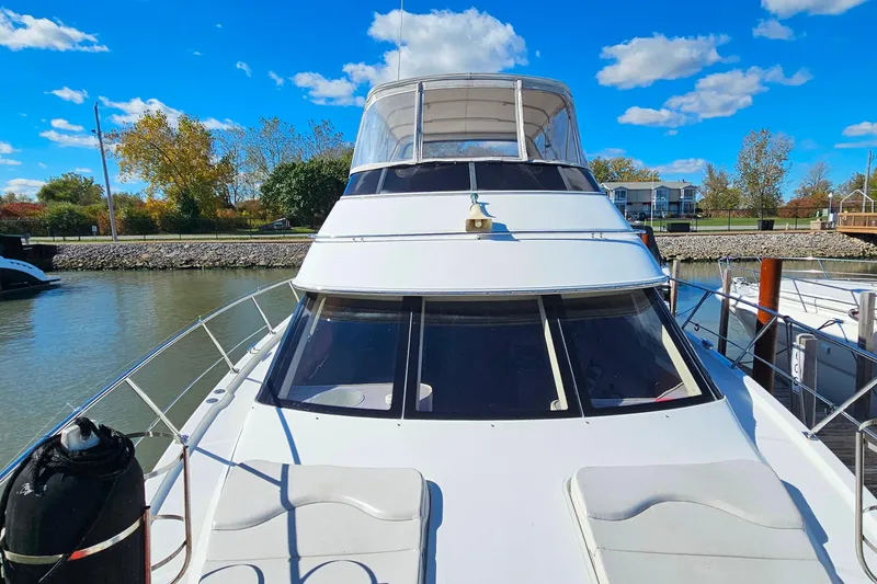 Slide: The Image of 2004 Carver 444 Cockpit Motor Yacht docked under a clear blue sky. - 28
