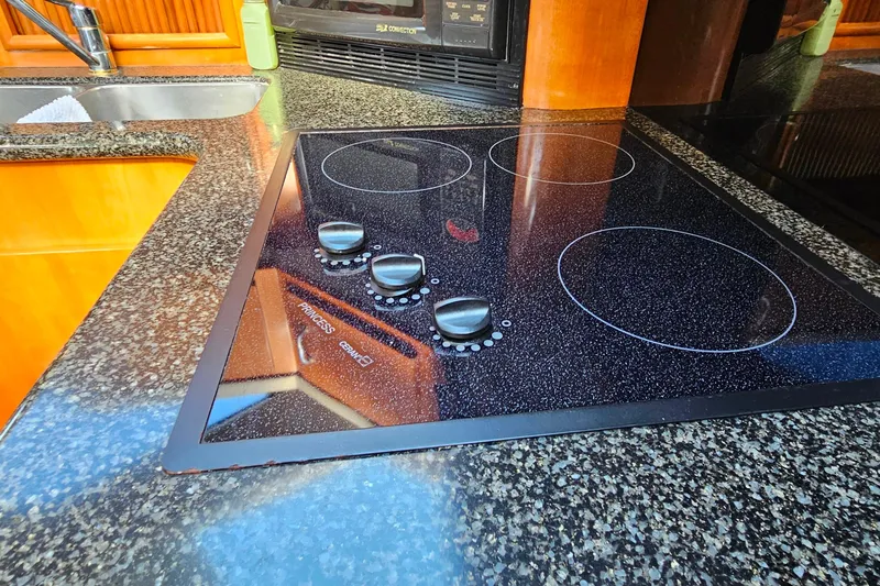 Slide: The Image of Modern kitchen stove in 2004 Carver 444 Cockpit Motor Yacht with granite countertop. - 33