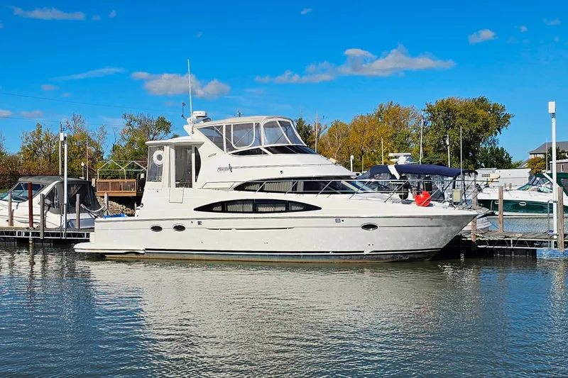 Slide: The Image of 2004 Carver 444 Cockpit Motor Yacht docked on a sunny day. - 4