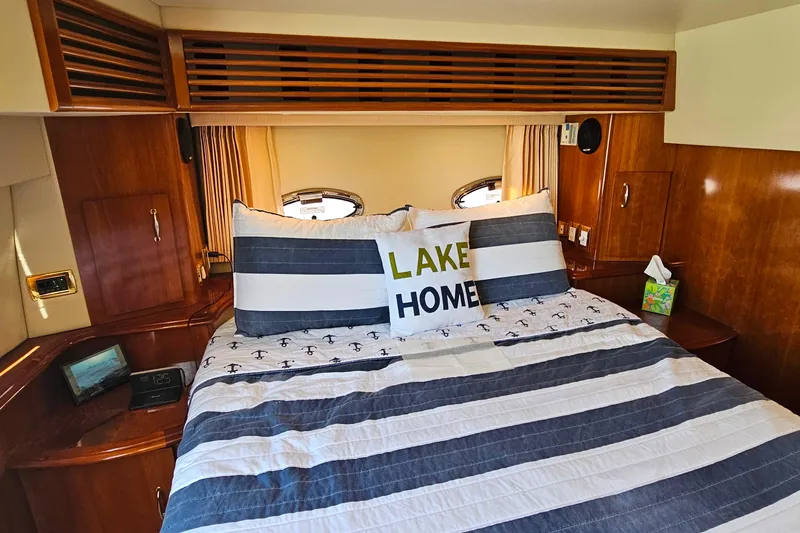 Slide: The Image of Cozy bedroom in 2004 Carver 444 Cockpit Motor Yacht with nautical-themed bedding. - 46