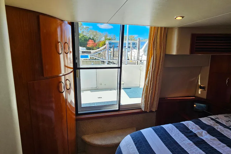 Slide: The Image of Interior of 2004 Carver 444 Cockpit Motor Yacht with window view and wood cabinetry. - 47