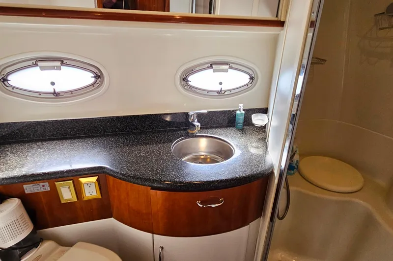 Slide: The Image of Bathroom interior of 2004 Carver 444 Cockpit Motor Yacht with sink and porthole windows. - 50