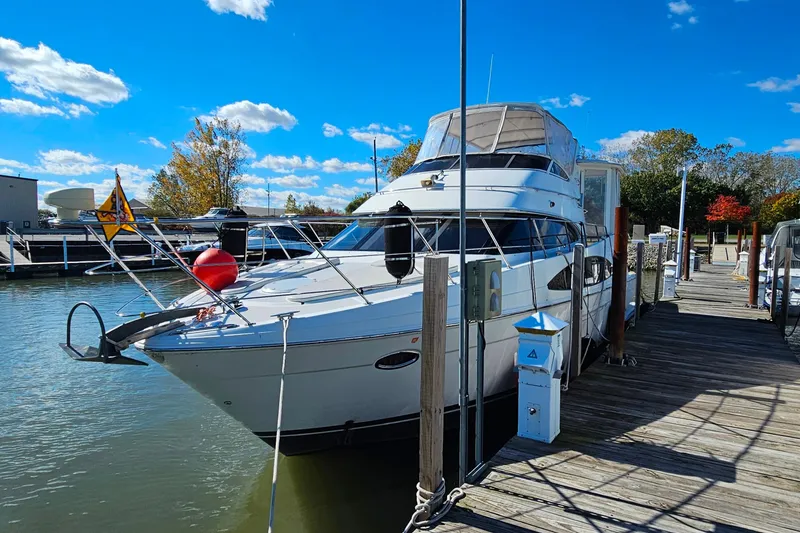 Slide: The Image of 2004 Carver 444 Cockpit Motor Yacht docked at marina under blue sky. - 7