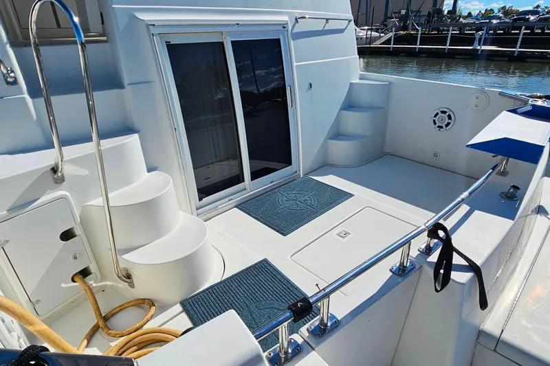 Slide: The Image of 2004 Carver 444 Cockpit Motor Yacht with steps and sliding door in marina. - 8