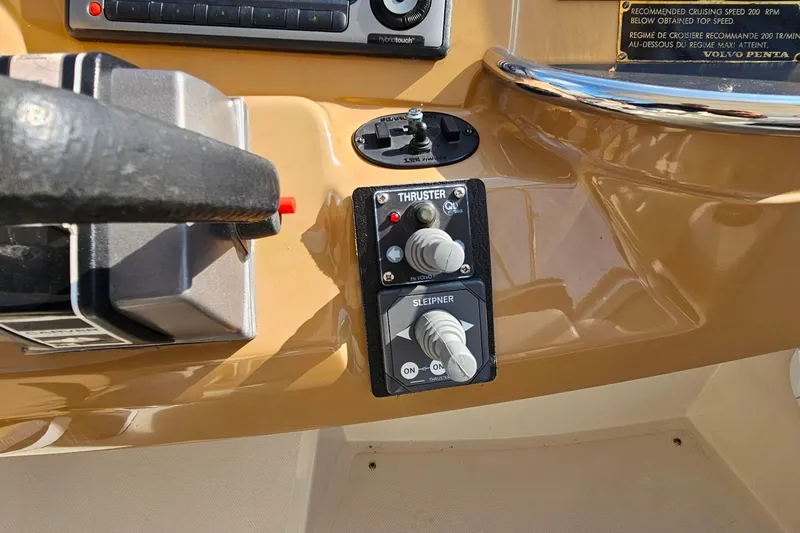 Slide: The Image of Control panel of a 2004 Carver 444 Cockpit Motor Yacht with thruster controls. - 19