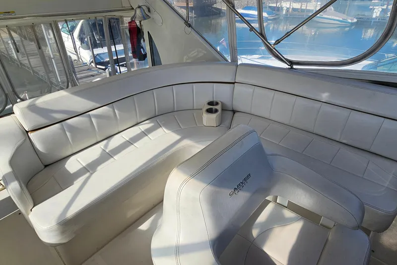 Slide: The Image of 2004 Carver 444 Cockpit Motor Yacht interior with white seating and cup holders. - 22