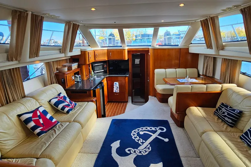 Slide: The Image of Luxurious interior of 2004 Carver 444 Cockpit Motor Yacht with elegant seating and nautical decor. - 29