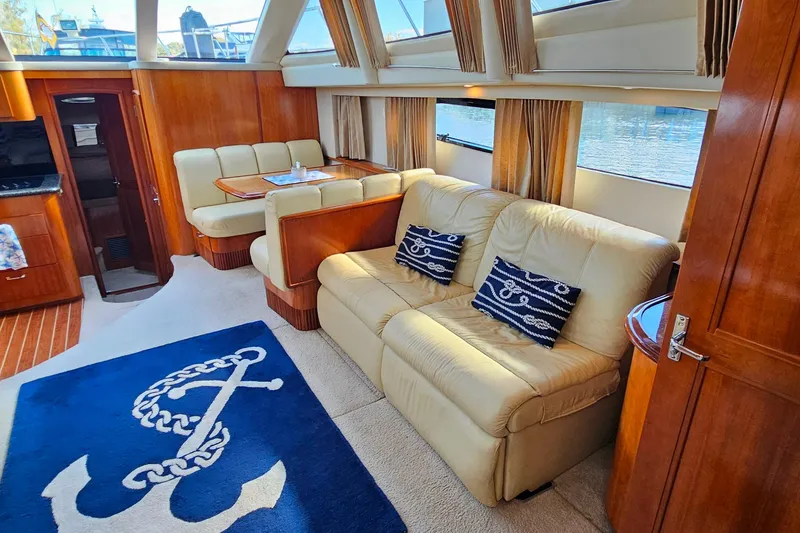 Slide: The Image of Luxurious interior of 2004 Carver 444 Cockpit Motor Yacht with elegant seating and nautical decor. - 30