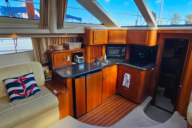 Slide: The Image of Luxurious 2004 Carver 444 Cockpit Motor Yacht interior with modern kitchen amenities. - 32