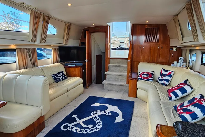 Slide: The Image of Luxurious interior of 2004 Carver 444 Cockpit Motor Yacht with nautical decor and plush seating. - 37