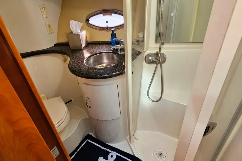 Slide: The Image of 2004 Carver 444 Cockpit Motor Yacht bathroom with sink, shower, and toilet. - 43