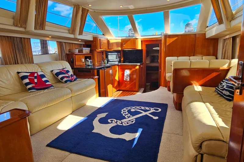 Slide: The Image of Luxurious interior of 2004 Carver 444 Cockpit Motor Yacht with plush seating and nautical decor. - 51