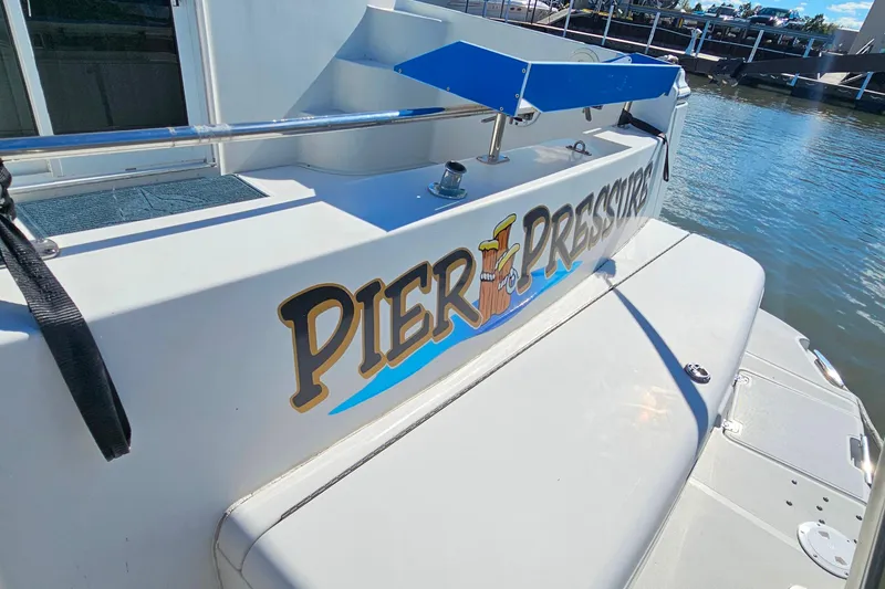 Slide: The Image of 2004 Carver 444 Cockpit Motor Yacht with "Pier Pressure" name at dock. - 9
