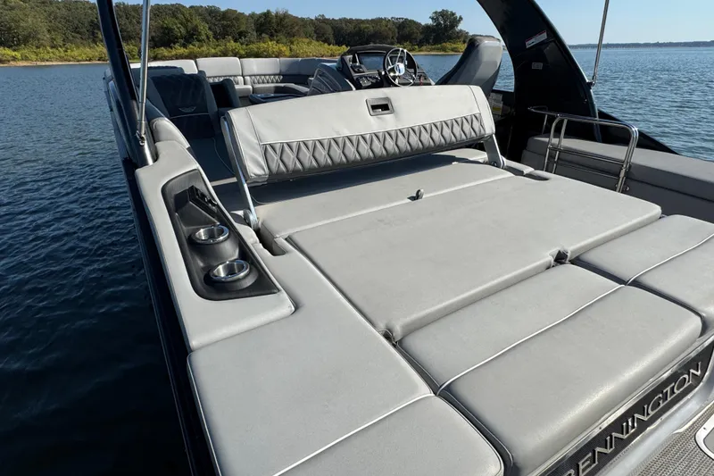 Slide: The Image of 2023 Bennington QX 27 QXSBAX2 luxury pontoon boat with spacious seating on a serene lake. - 25