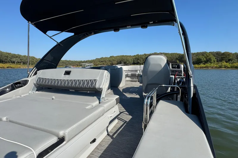 Slide: The Image of 2023 Bennington QX 27 QXSBAX2 pontoon boat interior on a sunny lake. - 26
